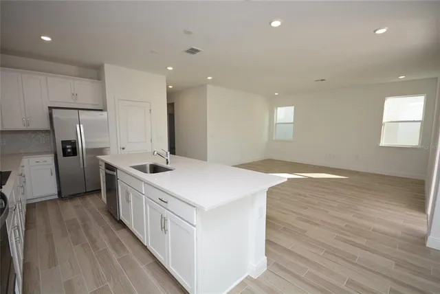 a kitchen with a sink a refrigerator and a stove