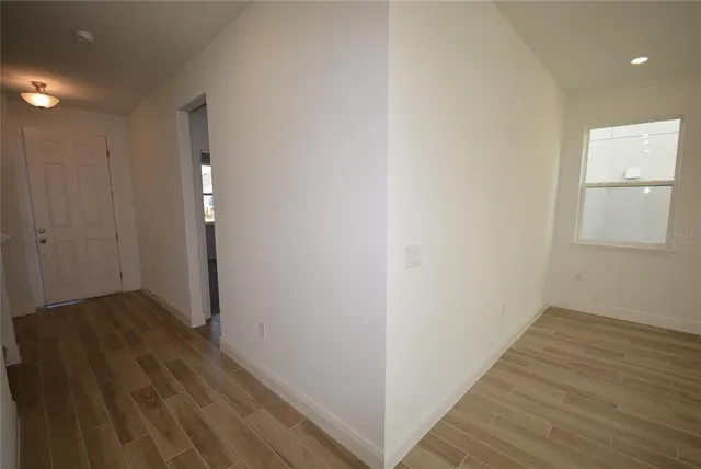 a view of a hallway with wooden floor