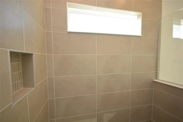 a bathroom with a window and a shower