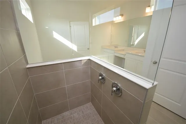 a bathroom with a shower and a sink