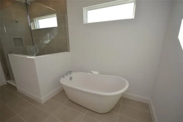 a white bath tub sitting in a bathroom