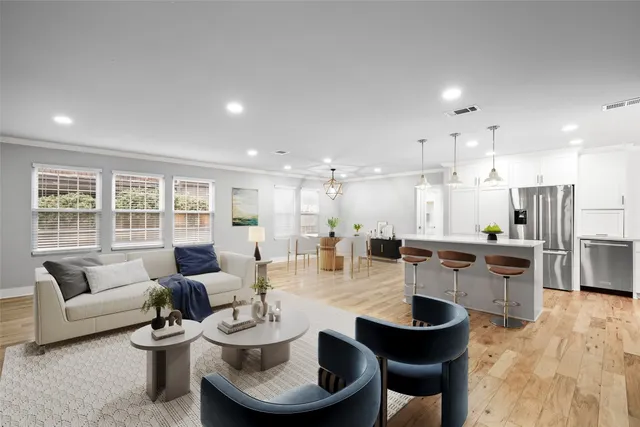 a dining room with furniture a table and kitchen view