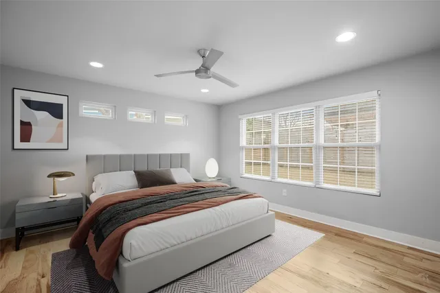 a bedroom with a large bed and a window