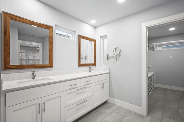 a bathroom with a double vanity sink mirror and