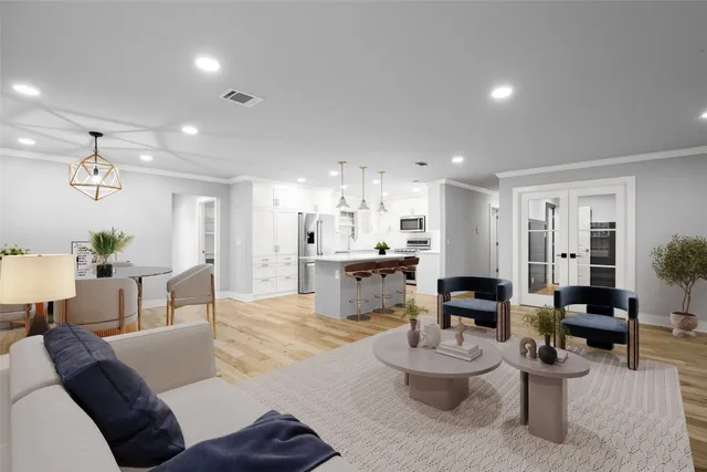 a living room with furniture and kitchen view