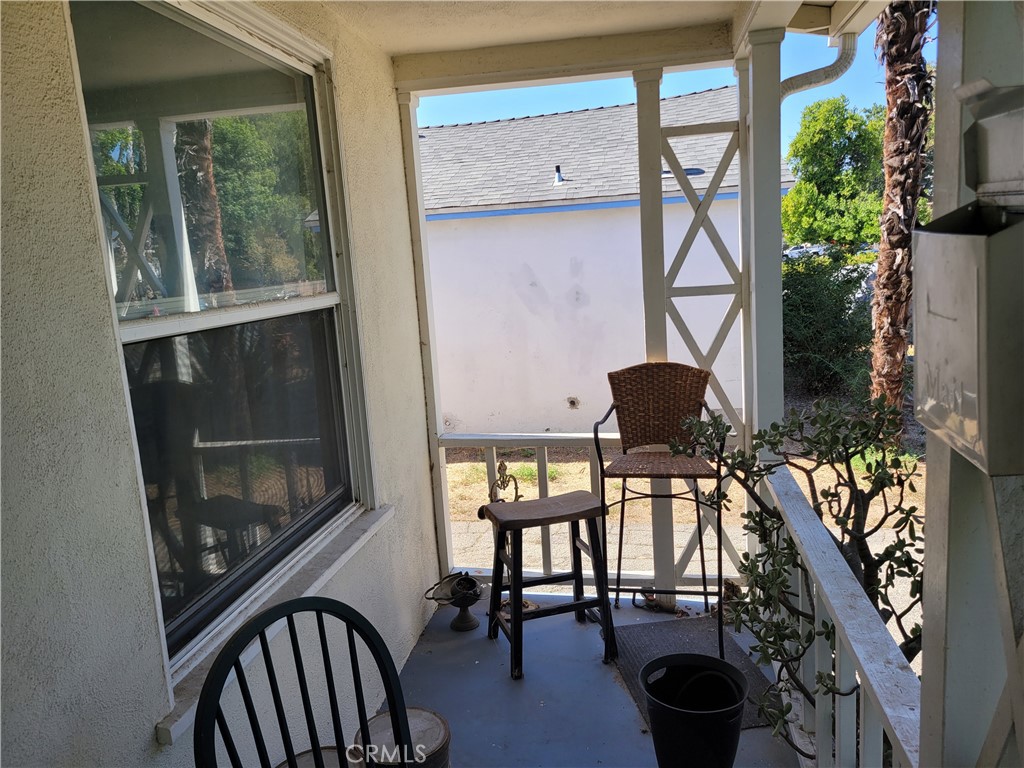 17638 Welby Way Lake Balboa, CA 91406 - Photo 2 of 3 a balcony with table and chairs
