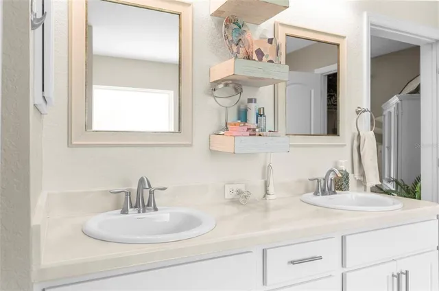 a kitchen with sink a microwave and cabinets