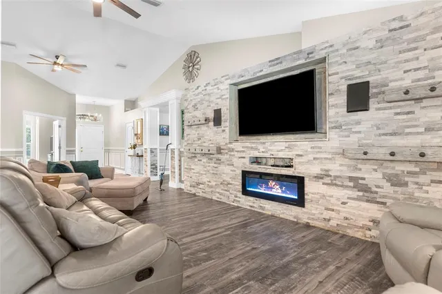 a kitchen with stainless steel appliances granite countertop a stove a sink a microwave a refrigerator and cabinets