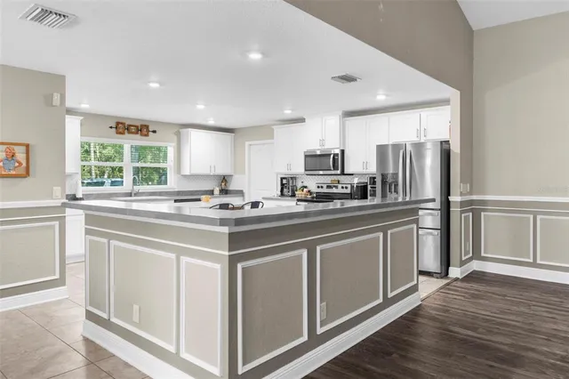 a bedroom with 2 bed and a desk