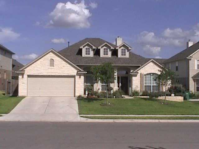 1217 Canyon Maple Road Pflugerville, TX 78660 - Photo 1 of 1 a front view of a house with a yard
