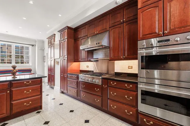 a living room with hard wood furniture and a window