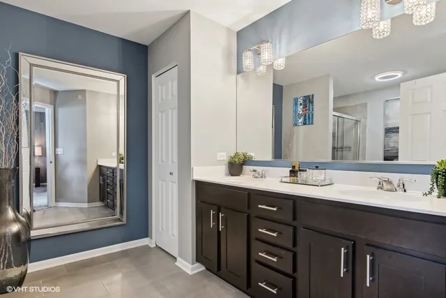 a bathroom with double sink and a mirror