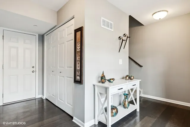 a view of an entryway with wooden floor