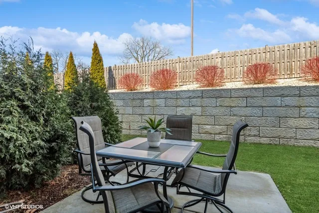 a view of a chairs and table in patio yard