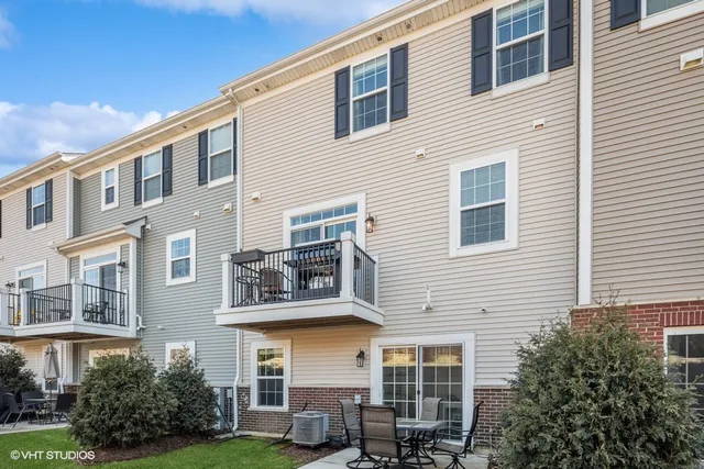 a front view of a residential apartment building with a yard