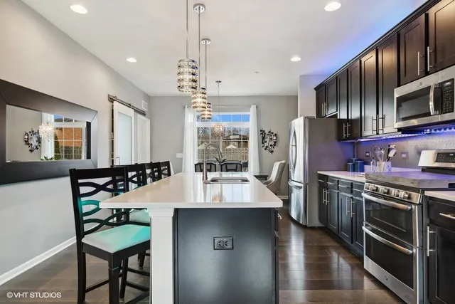 a large kitchen with a table and chairs