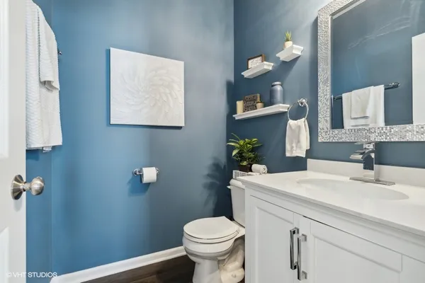 a bathroom with a sink a toilet and mirror