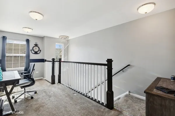 a view of workspace with wooden floor windows