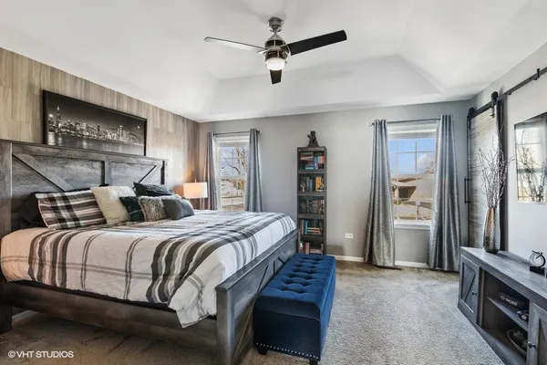 a bedroom with a bed and a chandelier