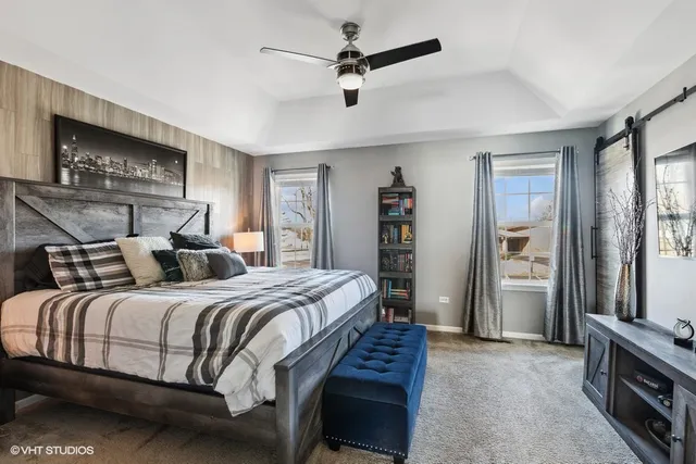 a bedroom with a bed and a chandelier