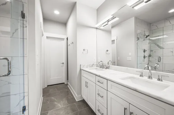 a spacious bathroom with a double vanity sink mirror and double