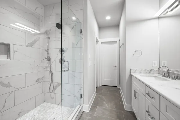 a spacious bathroom with a shower and a sink