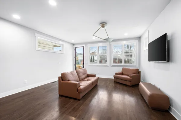 a living room with furniture windows and a flat screen tv