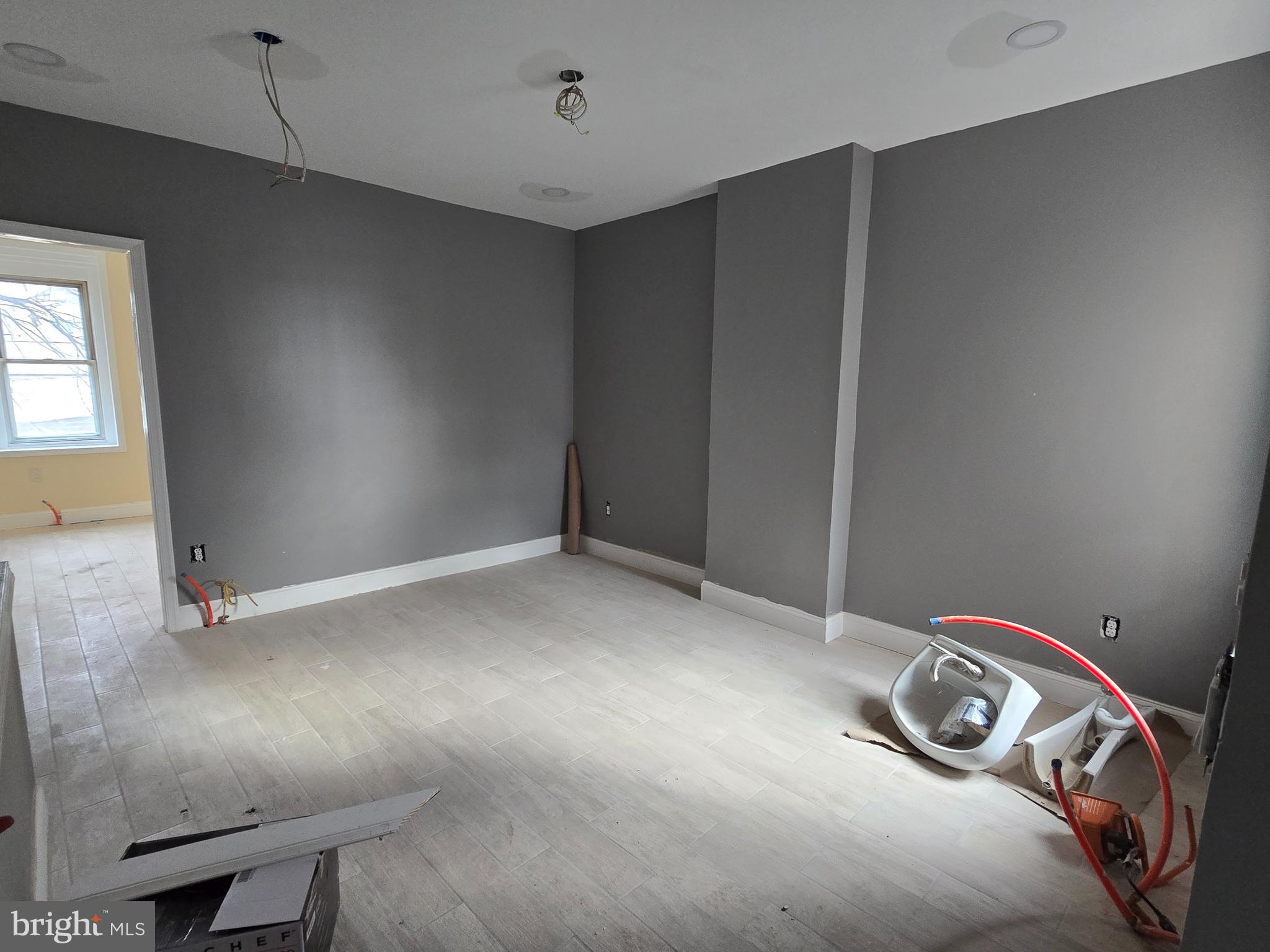 424 Highland Avenue Chester, PA 19013 - Photo 3 of 13 a view of a room with rack and wooden floor