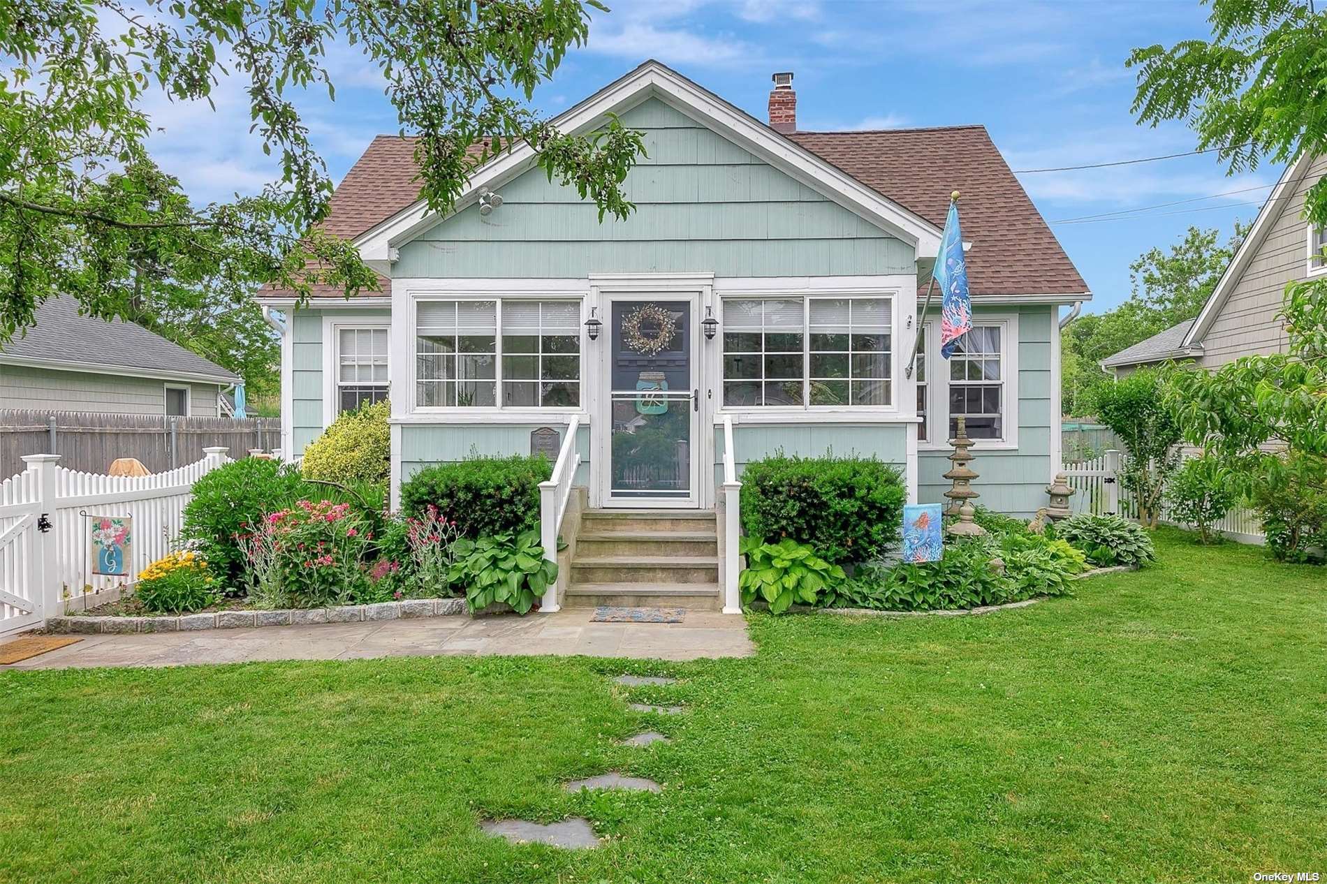 57 Ocean Avenue Blue Point, NY 11715 - Photo 1 of 1 a front view of a house with a yard and porch
