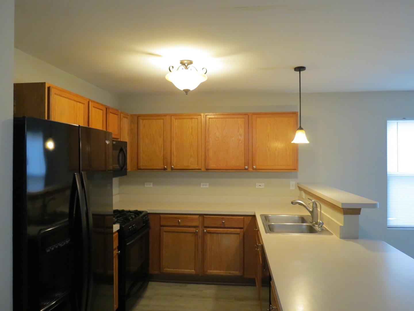 191 Mountain Laurel Court Romeoville, IL 60446 - Photo 11 of 29 a kitchen with a refrigerator and a sink