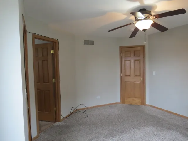 a view of a livingroom with a chandelier fan