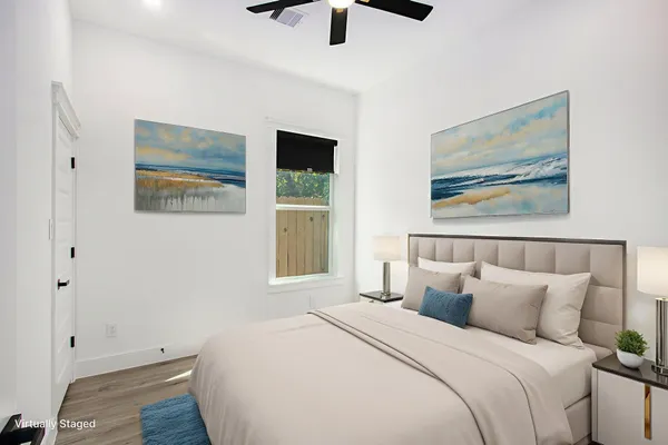 a bedroom with a bed and a painting on the wall