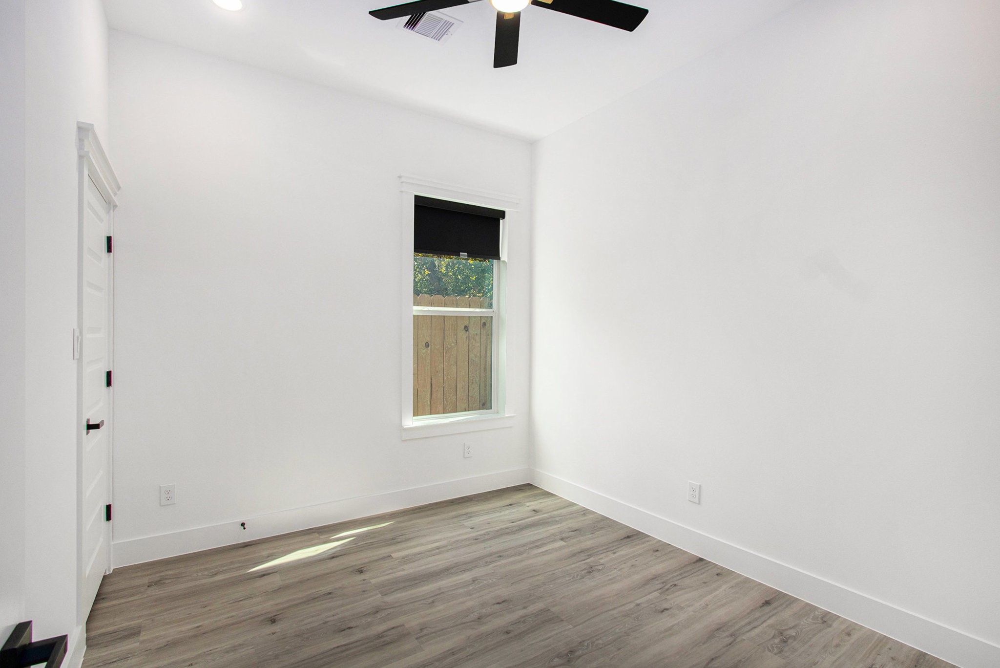 3652 Seabrook Street, Unit B Houston, TX 77021 - Photo 20 of 27 a view of an empty room with a window and wooden floor