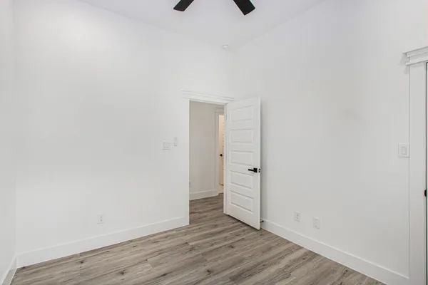 a view of an empty room with wooden floor