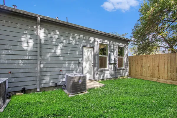 a backyard of a house with table and chairs