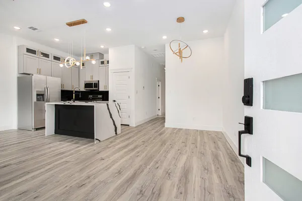 a kitchen with stainless steel appliances a refrigerator and a stove top oven