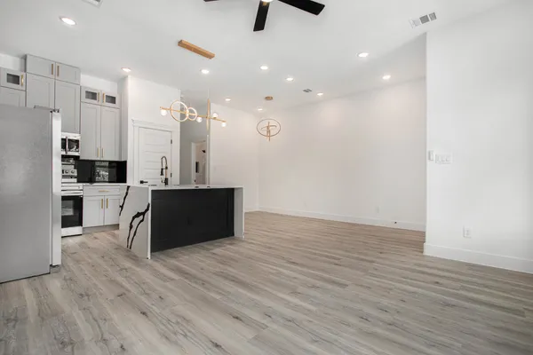 a kitchen with stainless steel appliances kitchen island wooden cabinets and granite counter tops