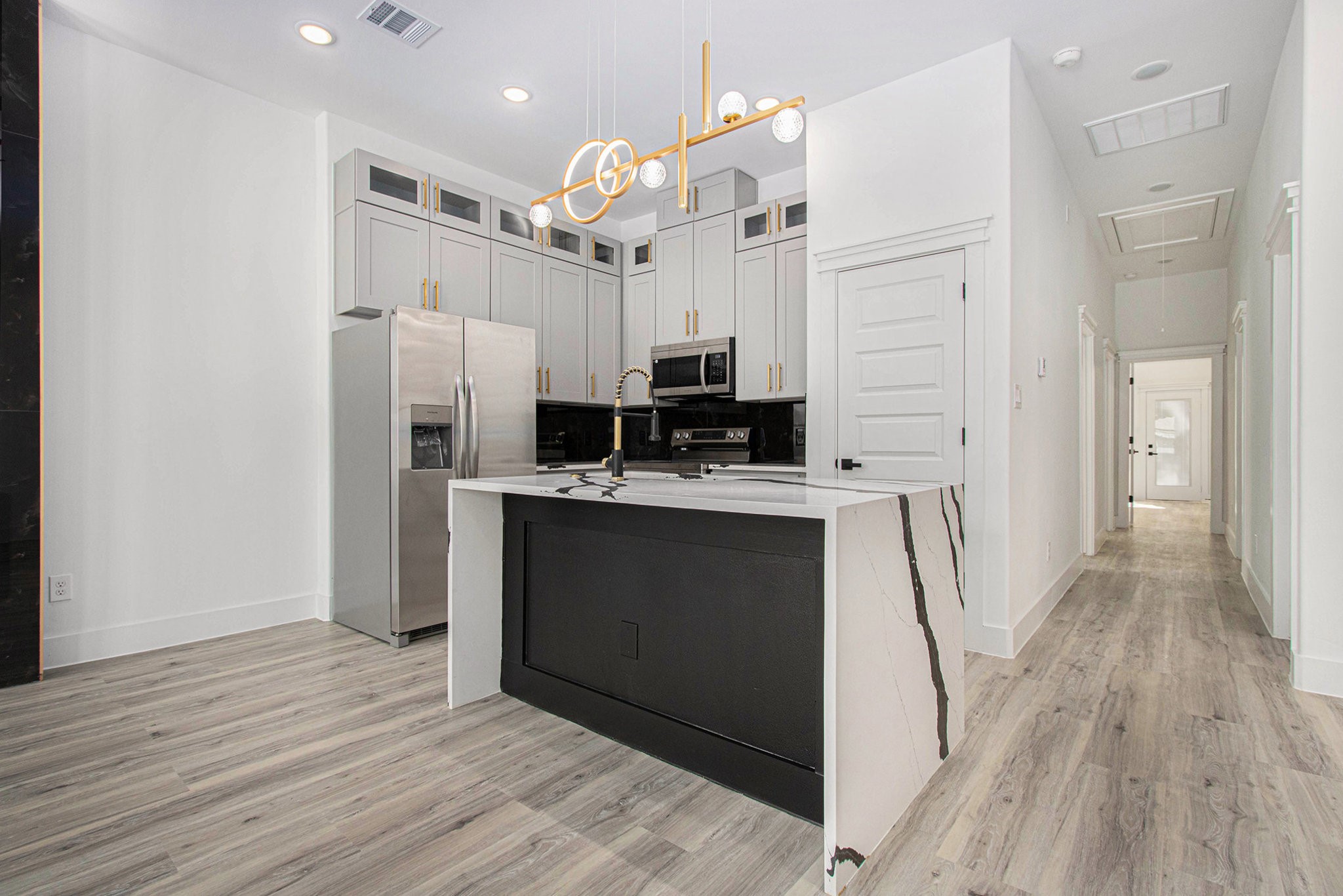 3652 Seabrook Street, Unit B Houston, TX 77021 - Photo 10 of 27 a kitchen with stainless steel appliances a refrigerator sink and microwave