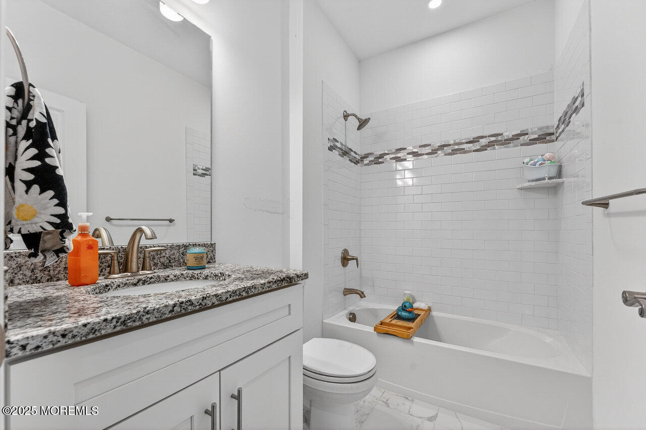 208 Prestige Road Brick, NJ 08723 - Photo 23 of 33 a bathroom with a granite countertop sink a toilet and shower