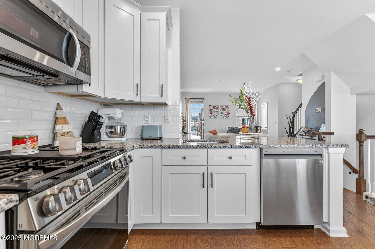 208 Prestige Road Brick, NJ 08723 - Photo 10 of 33 a kitchen with stainless steel appliances granite countertop a sink and cabinets