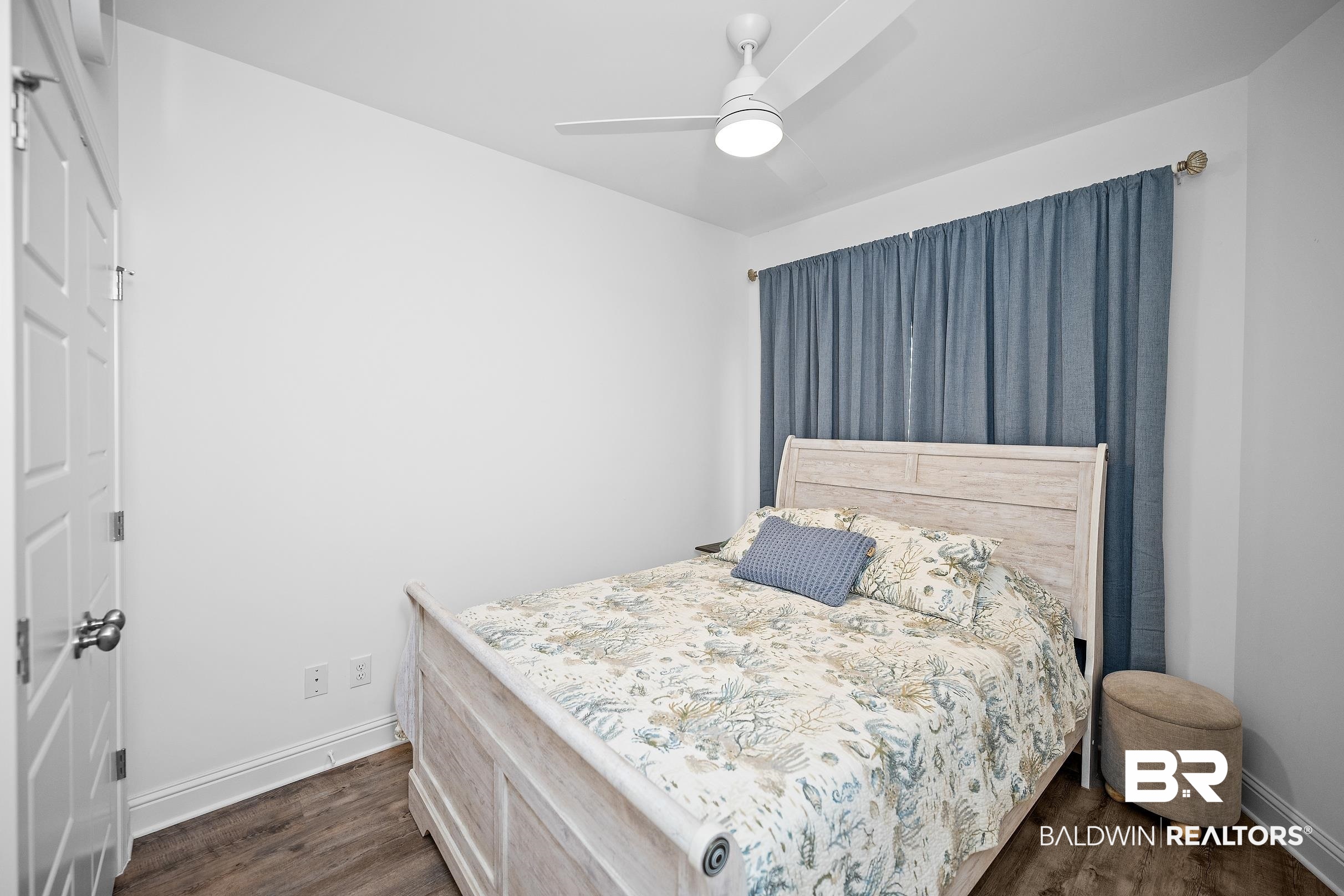 2651 South Juniper Street, Unit 2002 Foley, AL 36535 - Photo 17 of 23 Bedroom featuring wood-finish flooring, a white ceiling fan with integrated lighting, and white baseboards