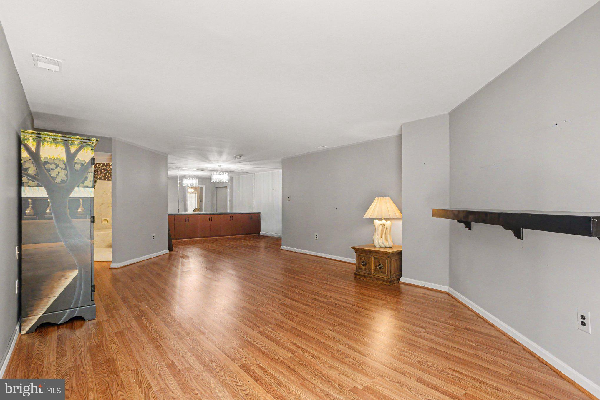 3021 Fallstaff Road, Unit 208B Baltimore, MD 21209 - Photo 5 of 25 a view of a room with wooden floor windows and chandelier