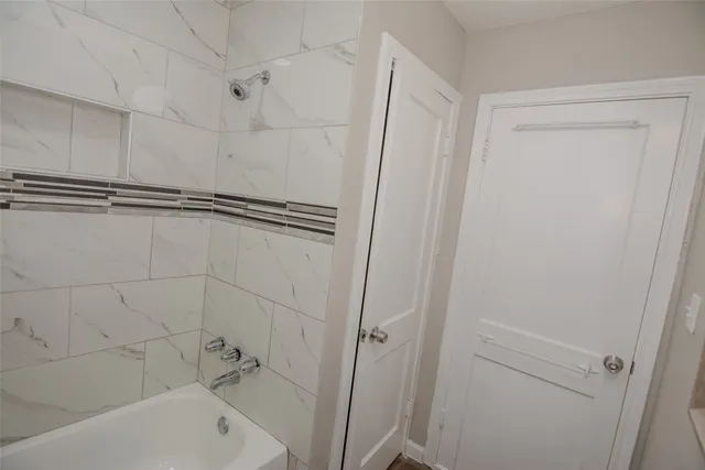 a bathroom with a bathtub and a shower