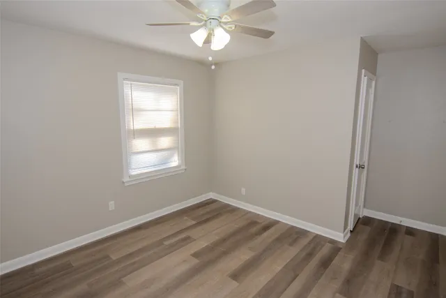 wooden floor in an empty room with a window