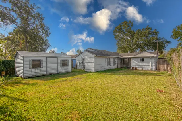 a front view of house with yard and swimming pool