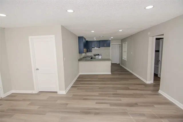 a view of kitchen with sink and refrigerator
