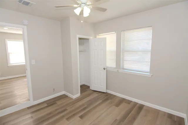 wooden floor in an empty room with a window