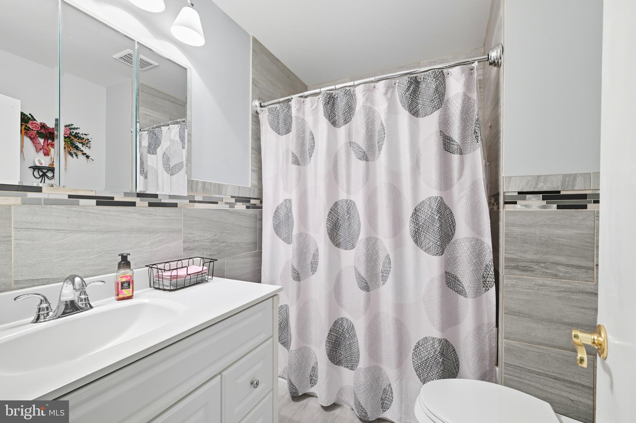 564 Byron Road Warminster, PA 18974 - Photo 17 of 49 a bathroom with a sink a toilet and a shower curtain