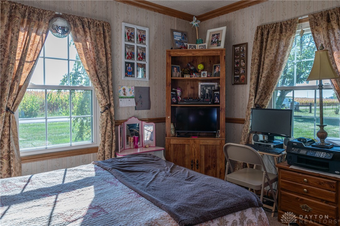 1599 Garringer Road Jamestown, OH 45335 - Photo 21 of 73 This cozy bedroom features bright windows, allowing natural light to fill the space.