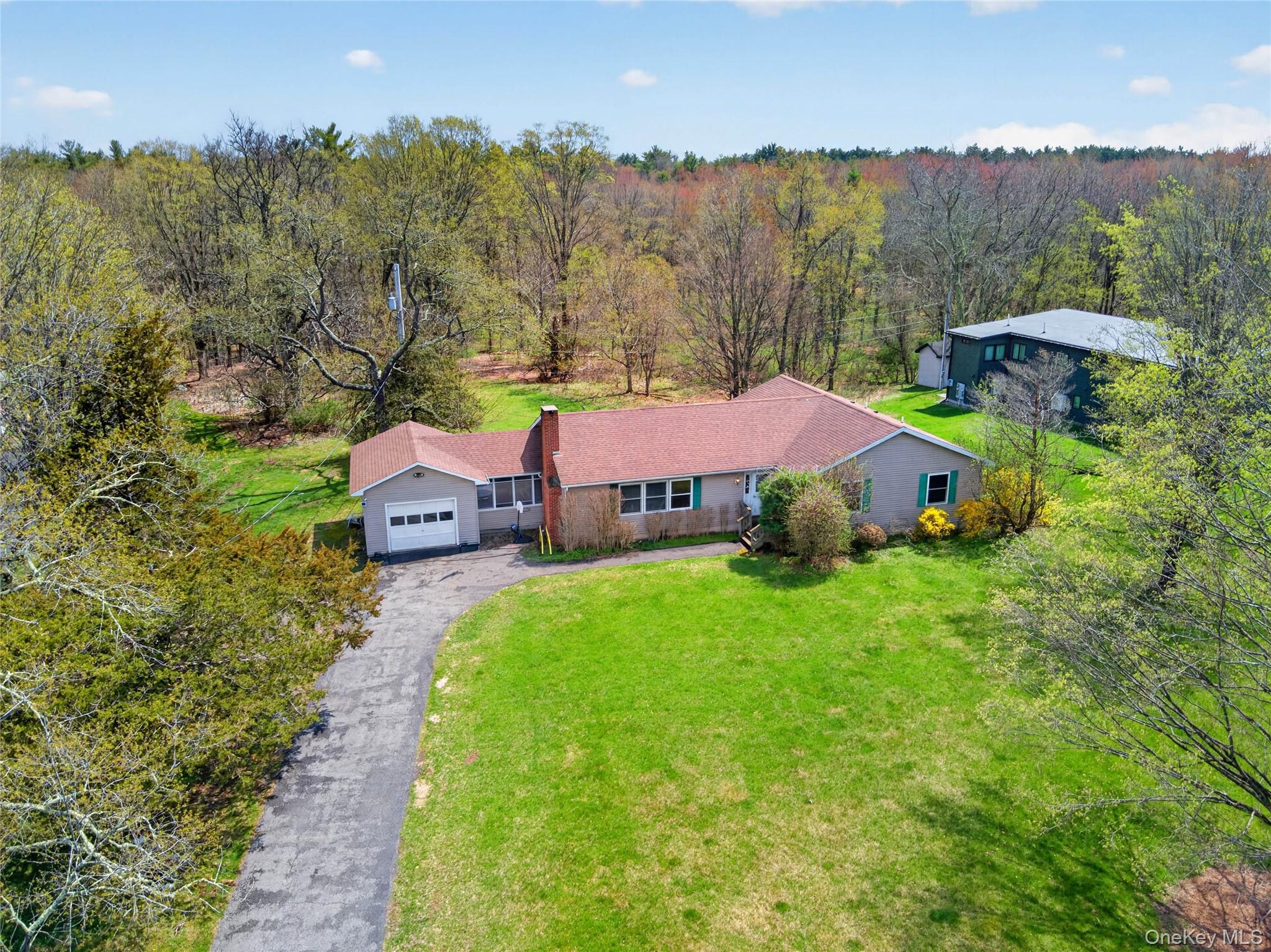 1044 Blue Mountain Road Saugerties, NY 12477 - Photo 1 of 32 a aerial view of a house with backyard and trees